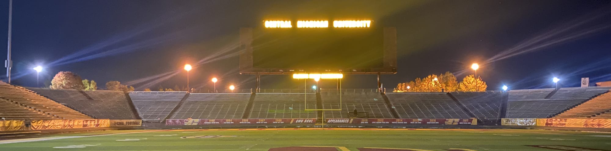 empty football stadium at night under the lights Tulsa