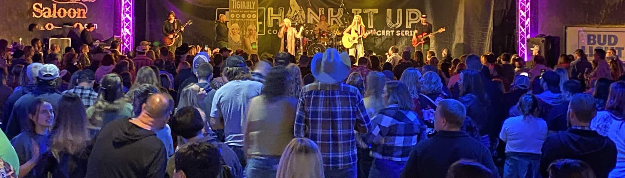 country concert with fans wearing cowboy hats Tulsa